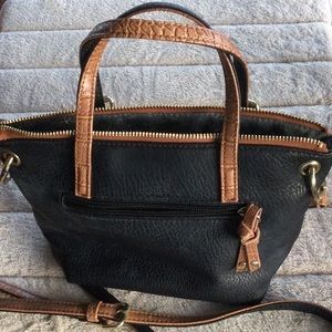 Two sided crossbody purse. Black & tan with two inside pockets & one outside.